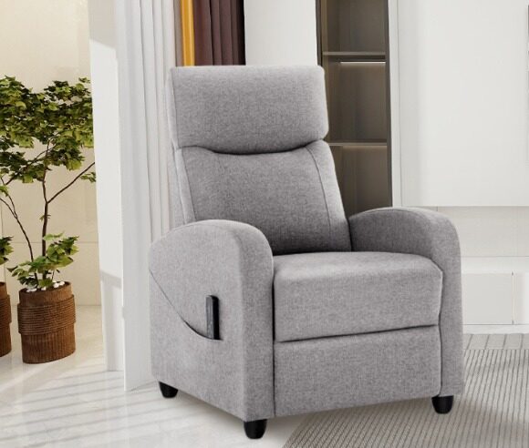 Grey massage recliner in a bright room with plants.