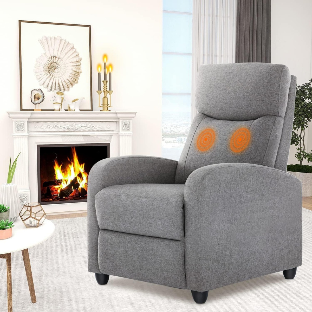 Grey massage recliner beside fireplace and round table.